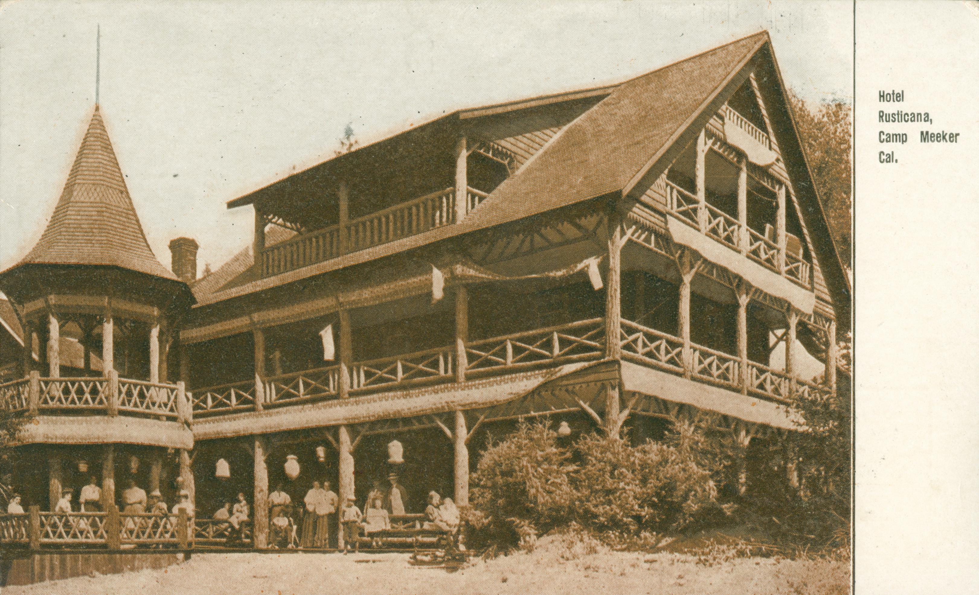 Shows a corner view of Hotel Rusticana with several visitors standing on the porch